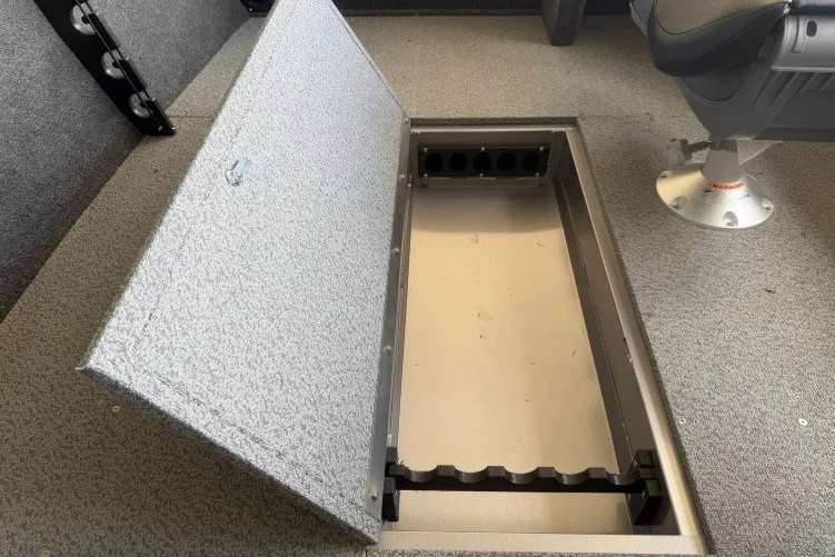 Slide: The Image of 2026 Crestliner 1650 Kodiak SC boat with open storage compartment. - 10