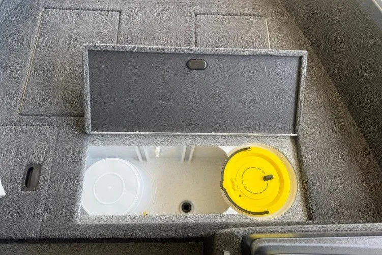 Slide: The Image of 2026 Crestliner 1650 Kodiak SC boat storage compartment with open lid, revealing interior space. - 6