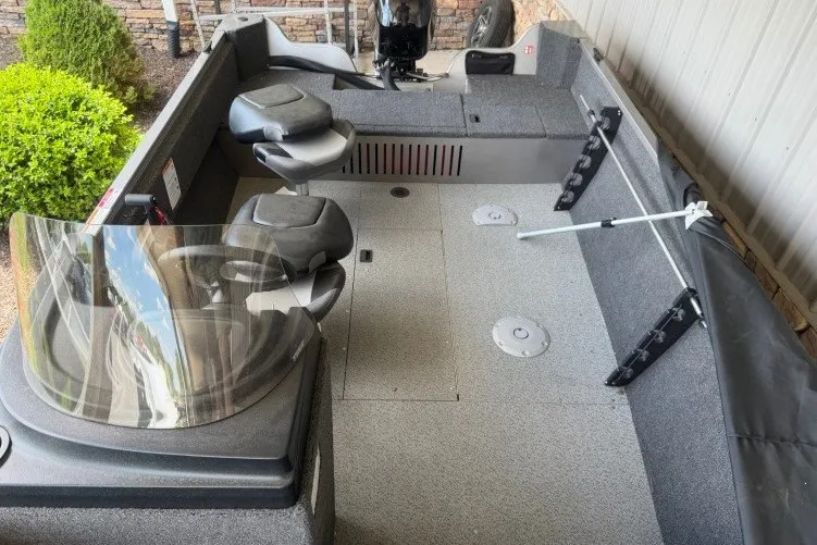 Slide: The Image of 2026 Crestliner 1650 Kodiak SC boat interior with seating and steering console. - 9