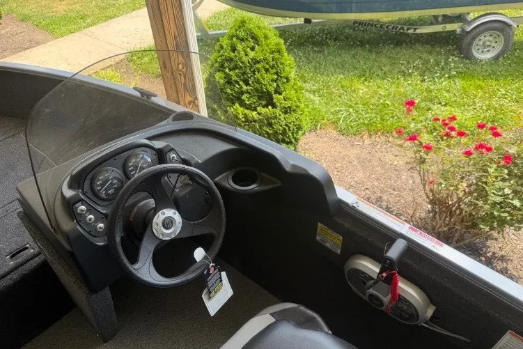 Slide: The Image of Interior view of 2026 Crestliner 1650 Kodiak SC boat with steering wheel and dashboard. - 7