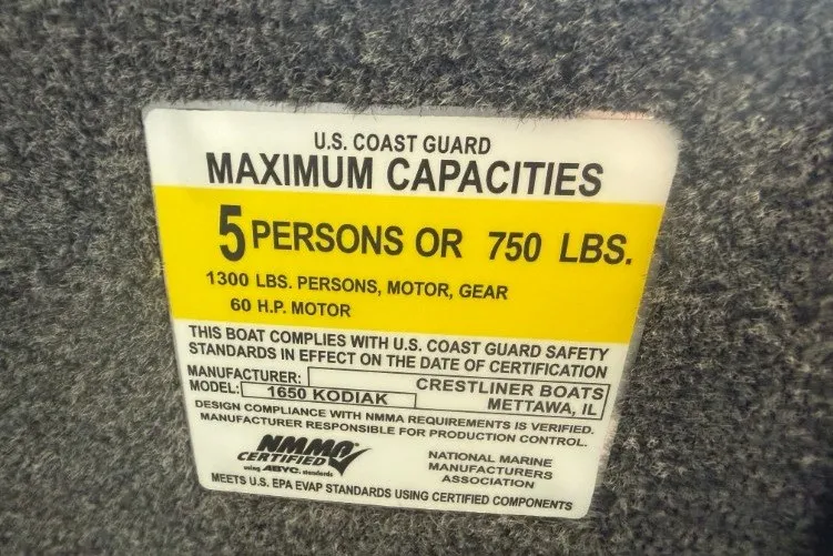 Slide: The Image of U.S. Coast Guard capacity label for 2026 Crestliner 1650 Kodiak SC boat. - 8