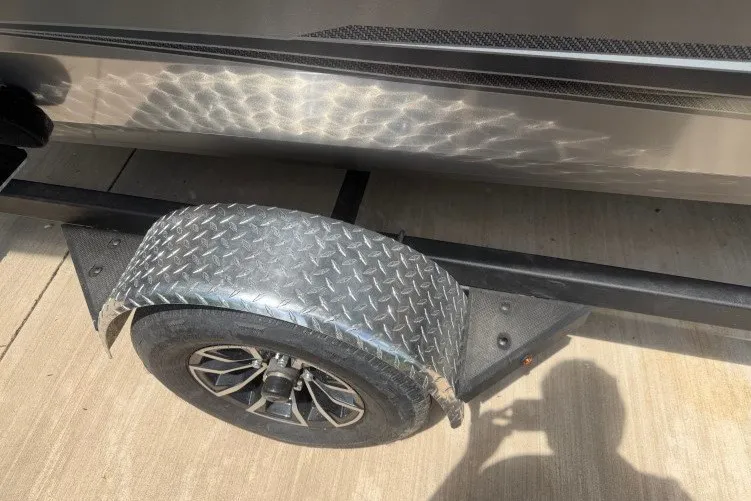 Slide: The Image of 2026 Crestliner 1650 Kodiak SC trailer with diamond plate fender and wheel on concrete surface. - 13