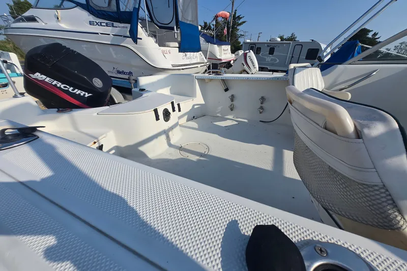 Slide: The Image of 2001 Bayliner 1700 Trophy Dual Console boat interior with Mercury outboard motor. - 3