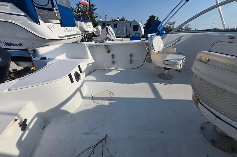 Slide: The Image of 2001 Bayliner 1700 Trophy Dual Console boat interior with seating and fishing equipment. - 9