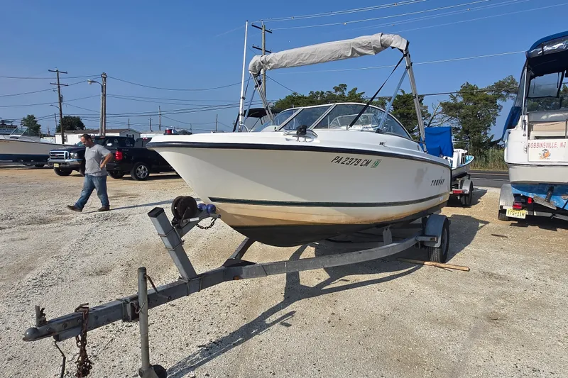Slide: The Image of 2001 Bayliner 1700 Trophy Dual Console boat on trailer in parking lot. - 7