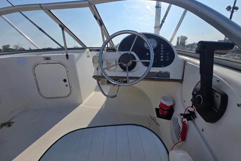 Slide: The Image of 2001 Bayliner 1700 Trophy Dual Console boat interior with steering wheel and dashboard. - 4