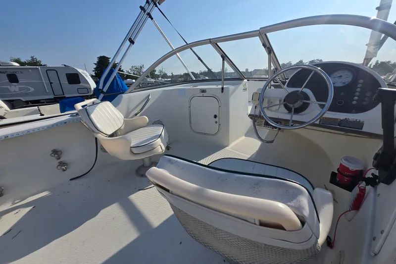 Slide: The Image of 2001 Bayliner 1700 Trophy Dual Console boat interior with steering wheel and seating. - 5