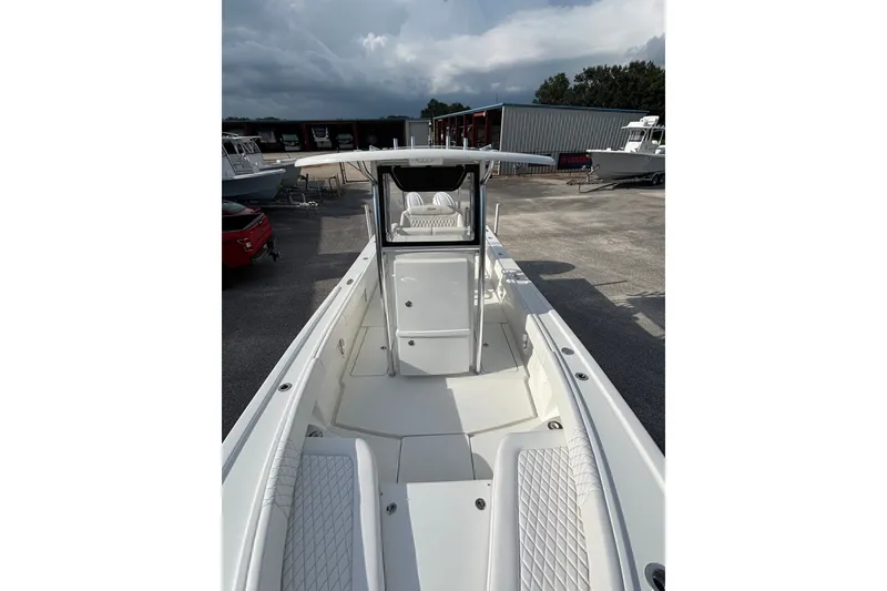 Slide: The Image of 2027 Pair Customs 24 Center Console DV Offshore boat, sleek design, docked outdoors. - 16