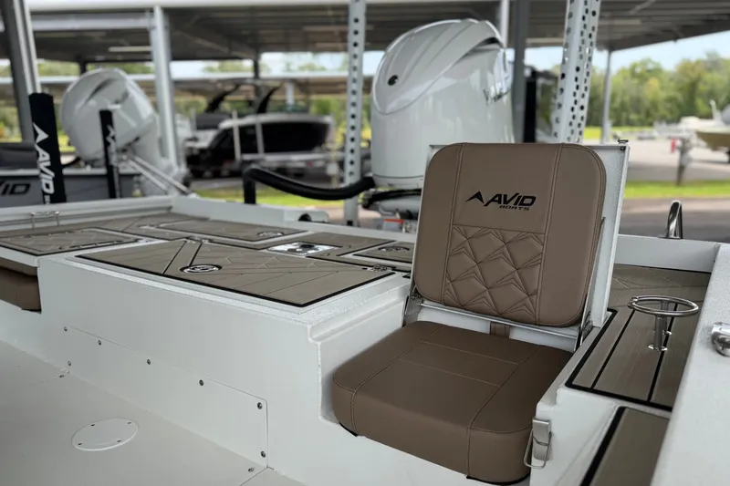 Slide: The Image of Avid 23 Fusion 2027 boat interior with brown seating and sleek design. - 16
