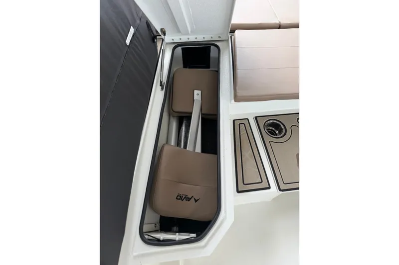 Slide: The Image of Storage compartment in 2027 Avid 23 Fusion boat with cushioned seating and cup holders. - 11