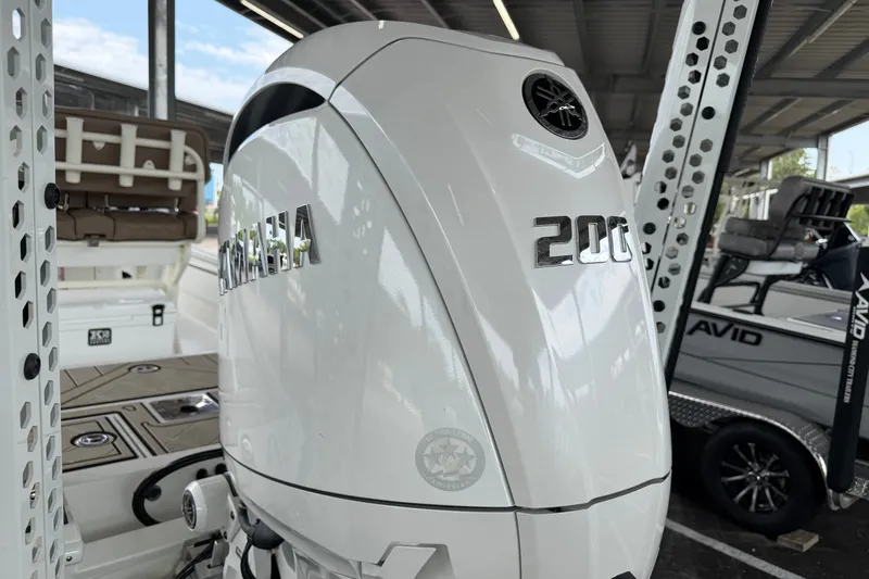 Slide: The Image of Avid 23 Fusion 2027 boat with Yamaha 200 engine in a covered dock. - 6