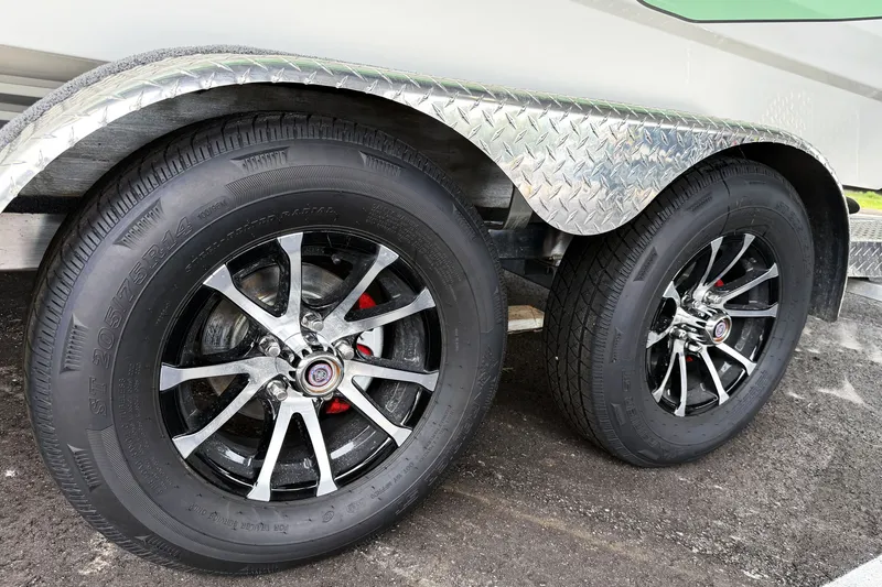 Slide: The Image of Dual wheels on a 2027 Avid 23 Fusion trailer with chrome rims and diamond plate fender. - 4
