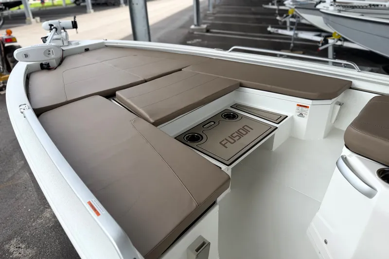 Slide: The Image of 2027 Avid 23 Fusion boat interior with cushioned seating and integrated cup holders. - 21