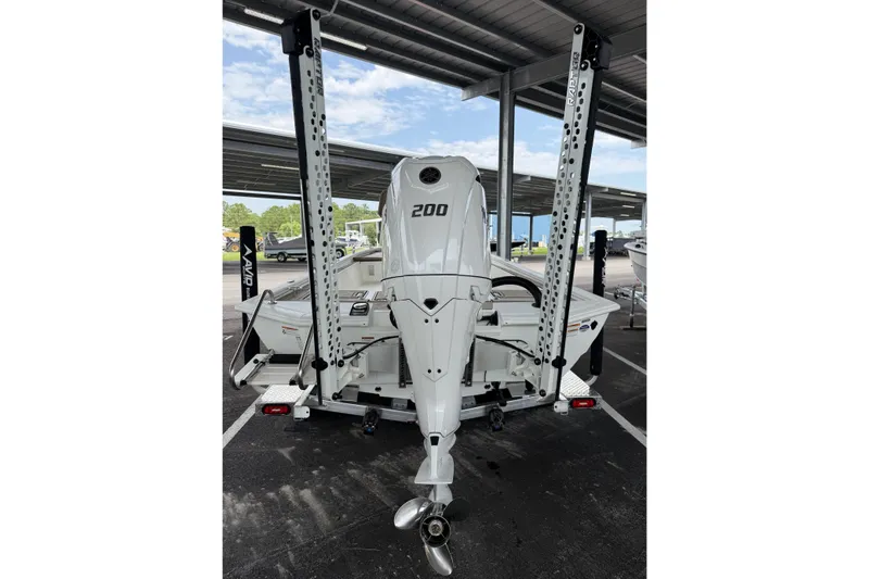Slide: The Image of Avid 23 Fusion 2027 boat with powerful 200 HP engine, parked under a shelter. - 7