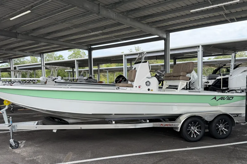 Slide: The Image of Avid 23 Fusion 2027 boat in storage, featuring sleek design and mint green accents. - 1