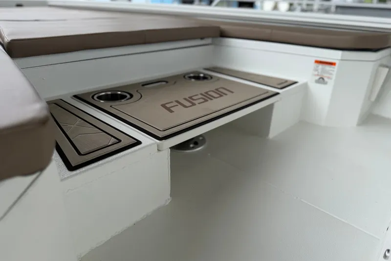 Slide: The Image of Interior of 2027 Avid 23 Fusion boat with cushioned seating and cup holders. - 20