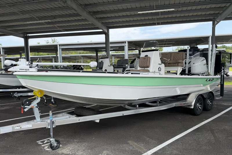 The Image of Avid 23 Fusion 2027 boat on trailer under shelter, featuring Minn Kota trolling motor. - 0