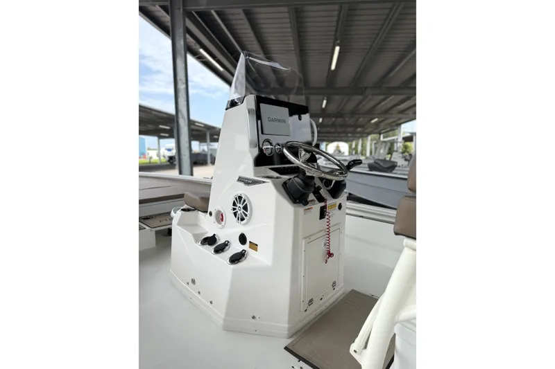 Slide: The Image of 2027 Avid 23 Fusion boat console with steering wheel and Garmin display. - 14