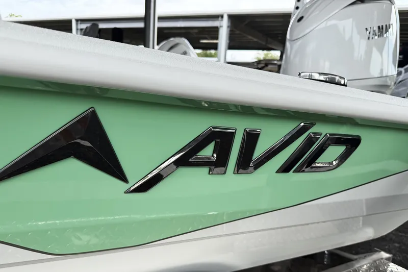 Slide: The Image of 2027 Avid 23 Fusion boat with sleek green and white design. - 5