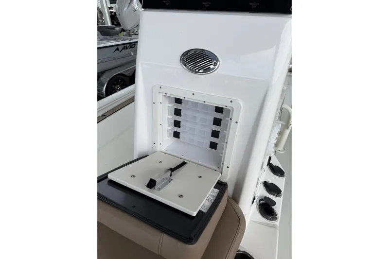 Slide: The Image of 2027 Avid 23 Fusion boat console with storage compartment and speaker. - 9