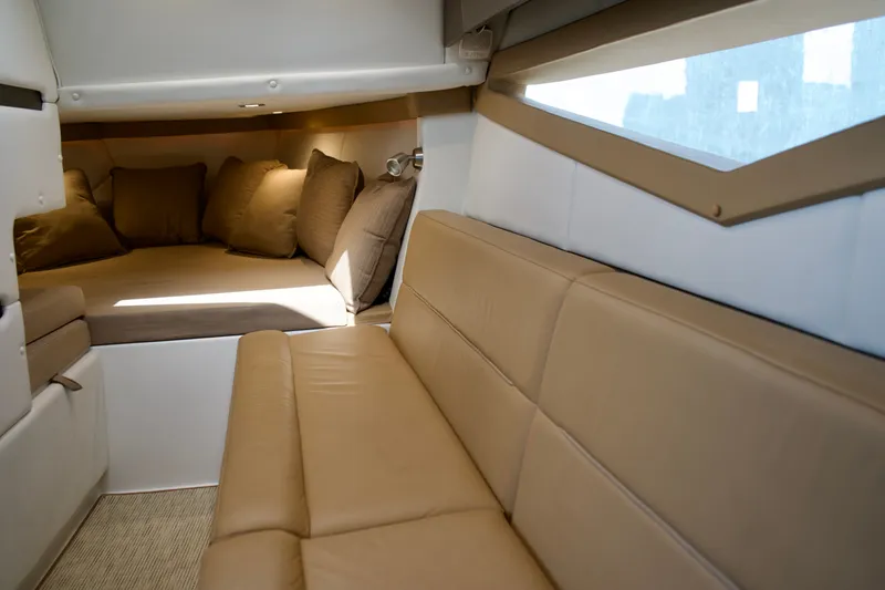 Slide: The Image of Interior of 2020 Cobalt A36 boat with beige seating and cozy cabin area. - 18