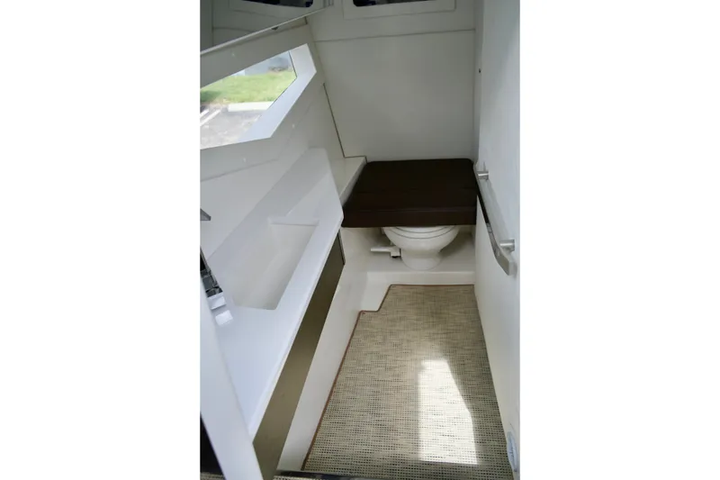 Slide: The Image of Interior of 2020 Cobalt A36 boat bathroom with toilet and seating area. - 17