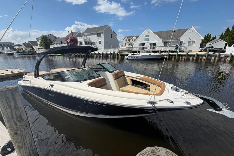 The Image of 2014 Sea Ray SLX 250 boat docked in a scenic waterfront neighborhood. - 0