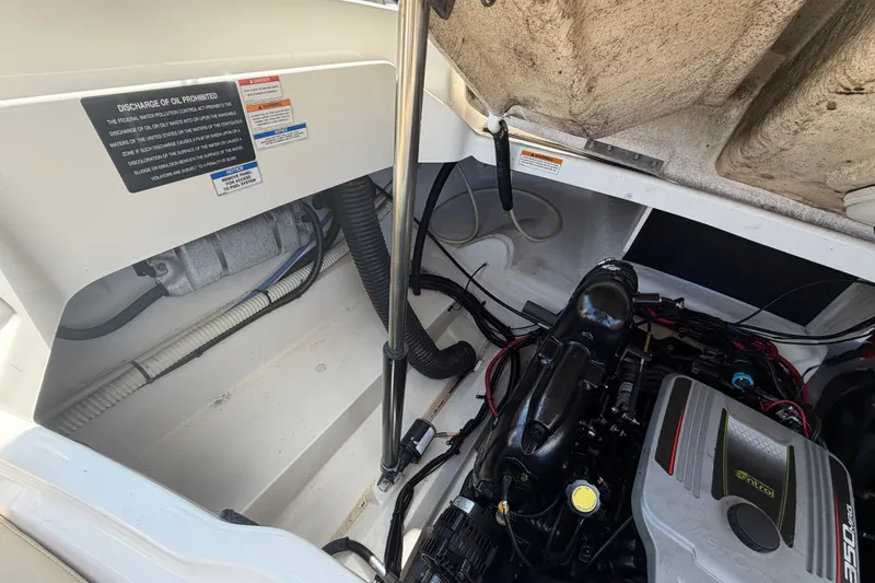 Slide: The Image of Engine compartment of a 2014 Sea Ray SLX 250 boat, showcasing detailed mechanical components. - 32