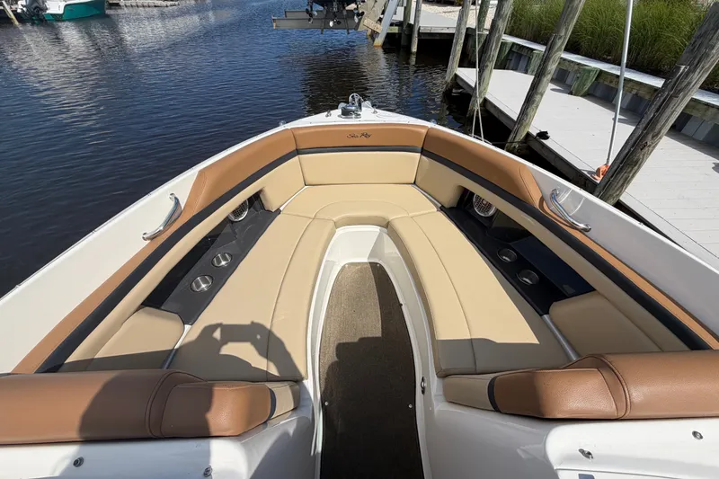 Slide: The Image of 2014 Sea Ray SLX 250 boat interior with tan leather seating and cup holders. - 5