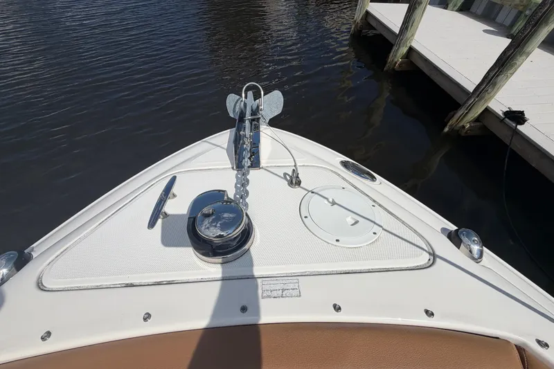 Slide: The Image of Bow view of 2014 Sea Ray SLX 250 boat docked, featuring anchor and deck details. - 10