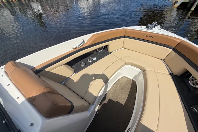 Slide: The Image of 2014 Sea Ray SLX 250 boat interior with tan seating and cup holders. - 6
