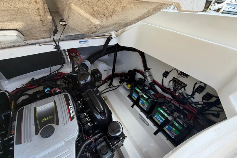 Slide: The Image of Engine compartment of a 2014 Sea Ray SLX 250 with batteries and wiring visible. - 31
