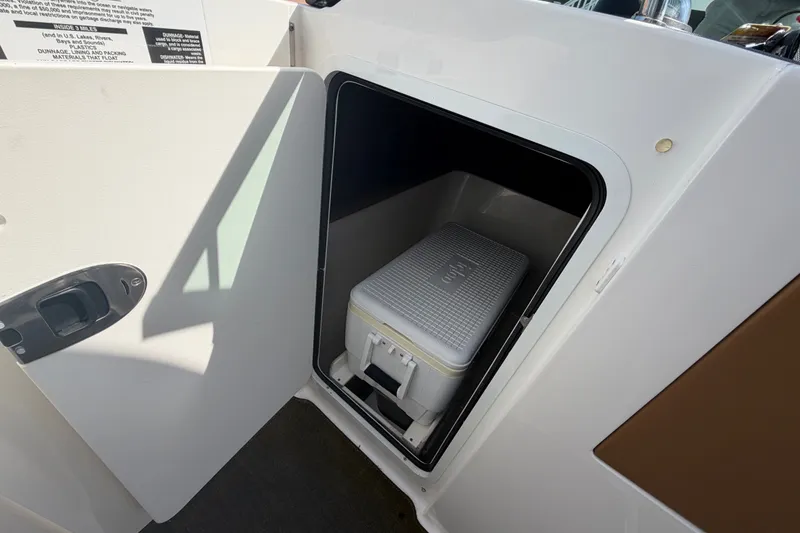 Slide: The Image of Storage compartment with cooler on a 2014 Sea Ray SLX 250 boat. - 14