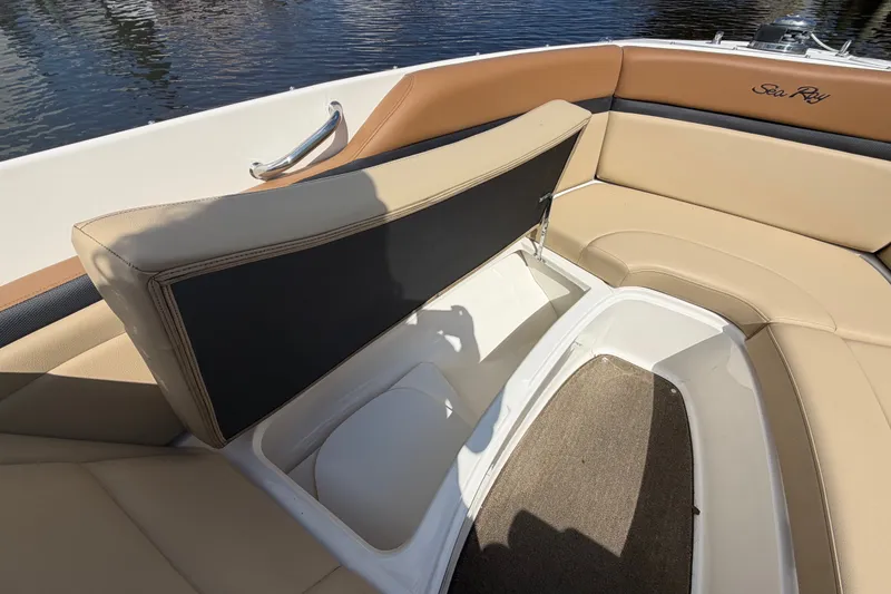 Slide: The Image of 2014 Sea Ray SLX 250 boat interior with tan seating and storage compartment. - 8