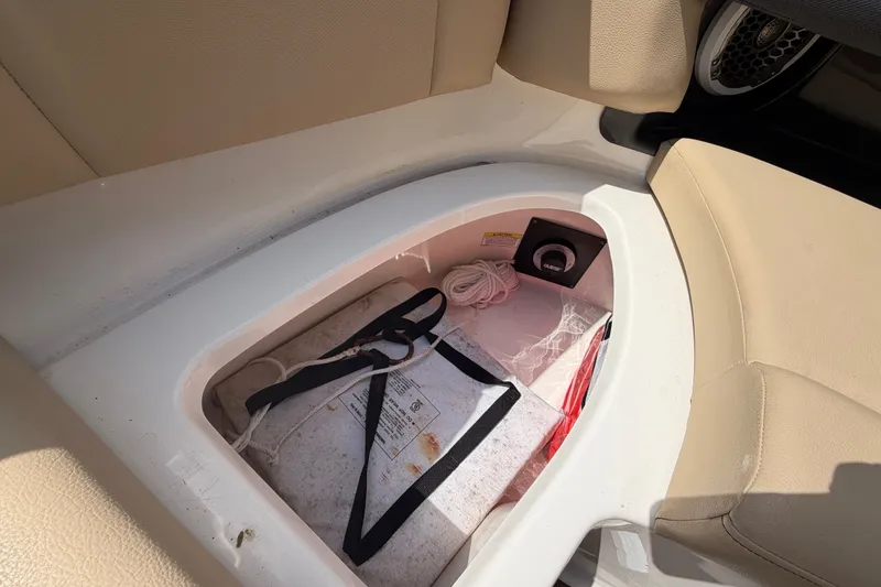 Slide: The Image of Storage compartment in a 2014 Sea Ray SLX 250 boat with beige seating. - 27