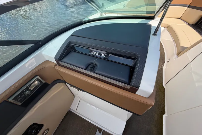 Slide: The Image of 2014 Sea Ray SLX 250 boat interior with dashboard and seating area. - 21