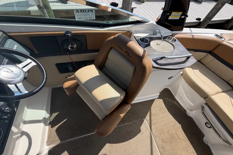 Slide: The Image of Interior of 2014 Sea Ray SLX 250 boat with helm, seating, and sink area. - 15