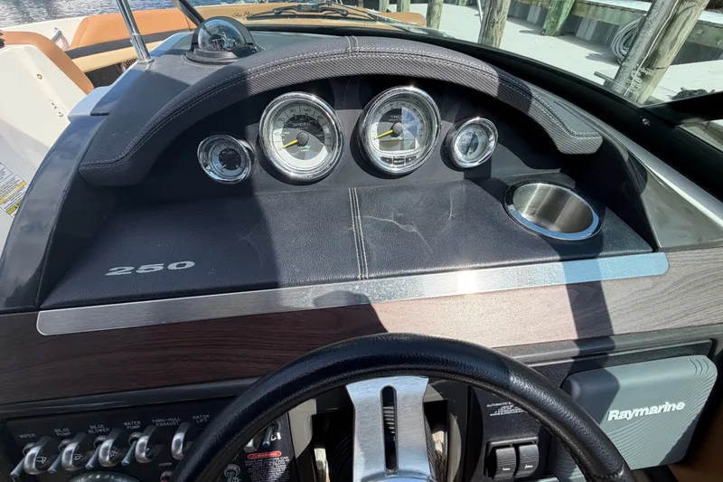 Slide: The Image of Dashboard of a 2014 Sea Ray SLX 250 boat with gauges and controls. - 17