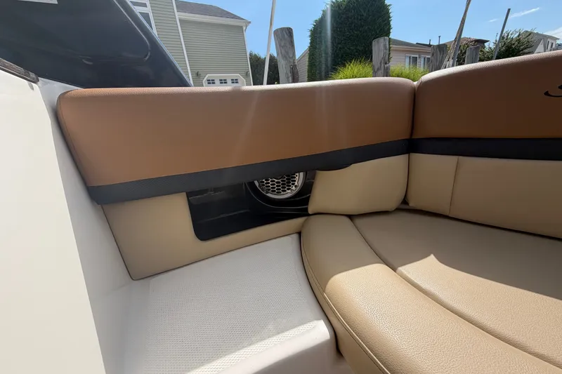 Slide: The Image of Interior seating of 2014 Sea Ray SLX 250 boat, featuring tan and beige upholstery. - 25