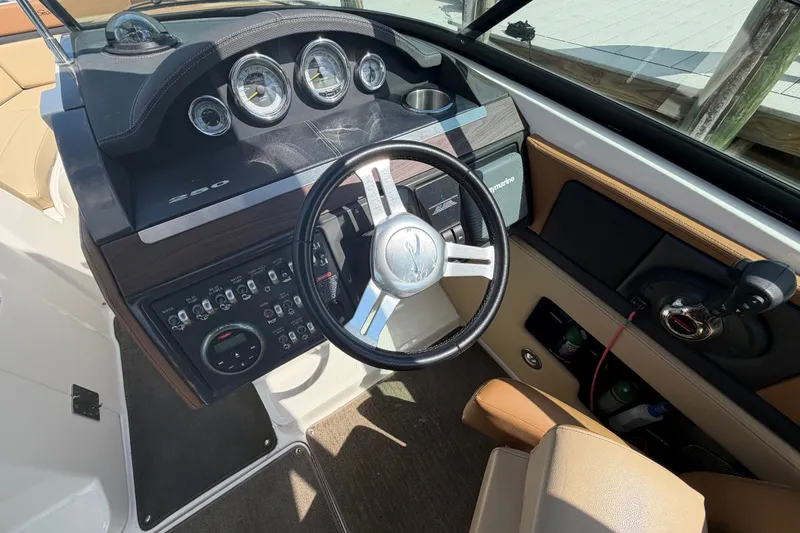 Slide: The Image of 2014 Sea Ray SLX 250 boat dashboard with steering wheel and control panel. - 16