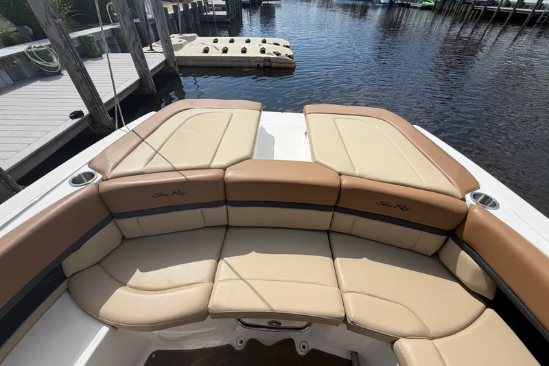 Slide: The Image of Luxurious 2014 Sea Ray SLX 250 boat interior with tan leather seating by the dock. - 24