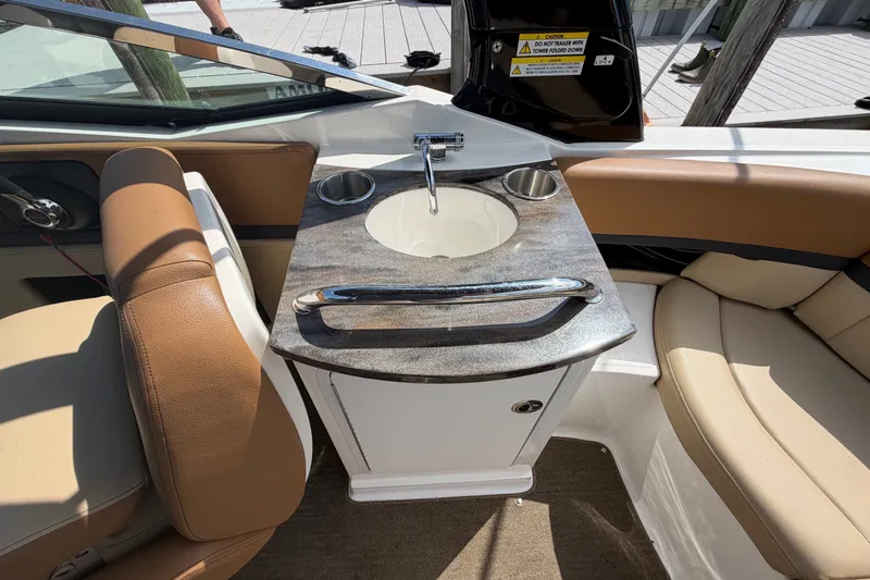 Slide: The Image of Interior of 2014 Sea Ray SLX 250 boat with sink and seating area. - 18