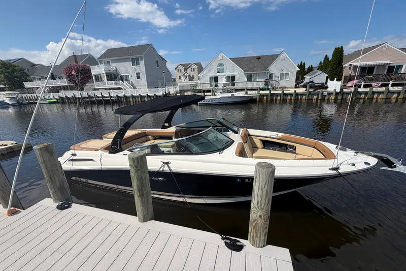 Slide: The Image of 2014 Sea Ray SLX 250 boat docked in a residential marina setting. - 3