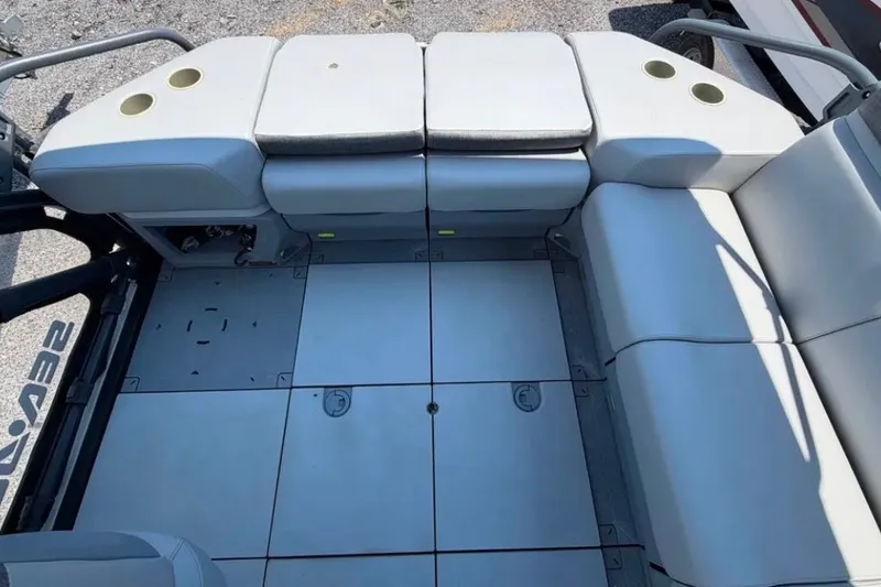 Slide: The Image of 2023 Sea-Doo Switch Cruise 21 interior seating with cup holders and modular floor design. - 9