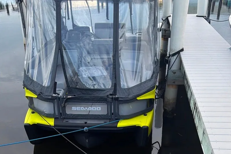 Slide: The Image of 2023 Sea-Doo Switch Cruise 21 docked, featuring a protective canopy and vibrant yellow accents. - 2