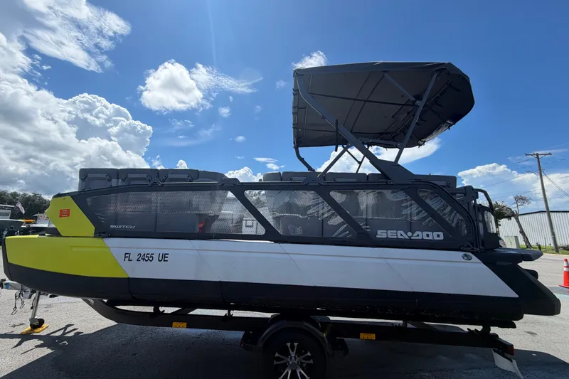 Slide: The Image of 2023 Sea-Doo Switch Cruise 21 pontoon boat on trailer under a clear blue sky. - 8