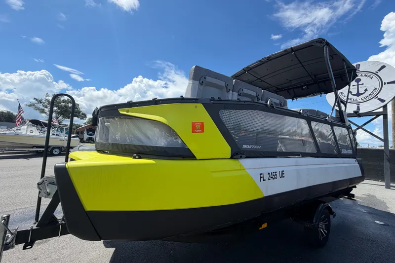 Slide: The Image of 2023 Sea-Doo Switch Cruise 21 boat with vibrant yellow accents under a clear blue sky. - 9