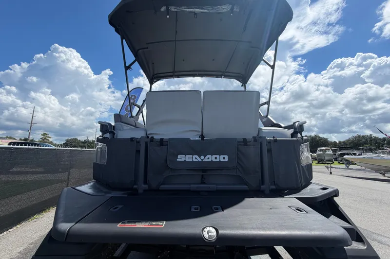 Slide: The Image of 2023 Sea-Doo Switch Cruise 21 pontoon boat under a cloudy sky. - 3