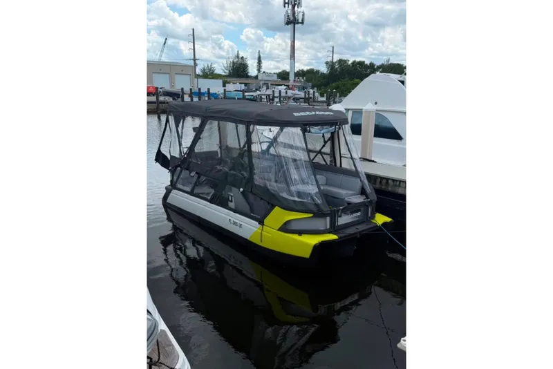 The Image of 2023 Sea-Doo Switch Cruise 21 pontoon boat docked, featuring a canopy and sleek design. - 4