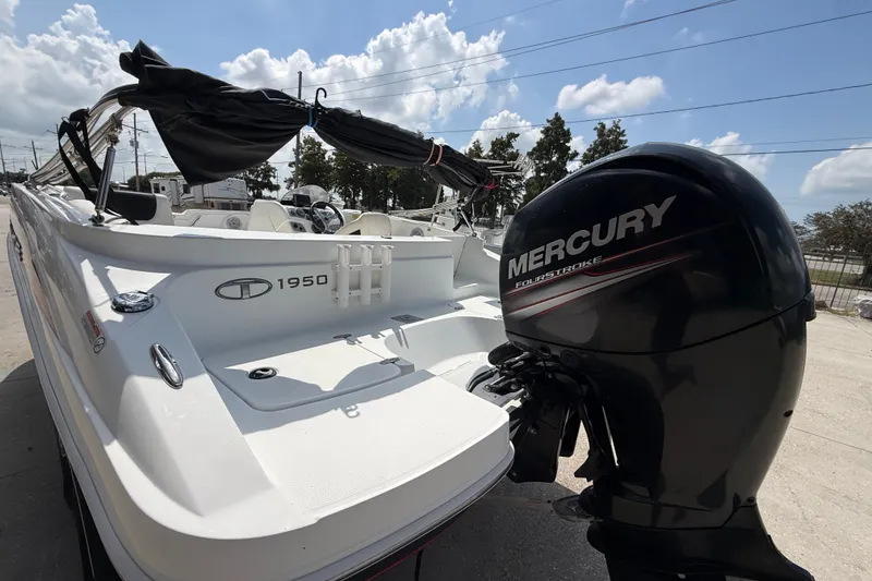 Slide: The Image of Tahoe 1950 boat from 2017 with Mercury FourStroke engine, parked outdoors. - 12